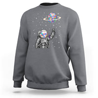 Charcoal astronaut graphic sweatshirt with colorful planet balloon and starry design
