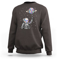 Dark chocolate astronaut graphic sweatshirt with colorful planet balloon and stars
