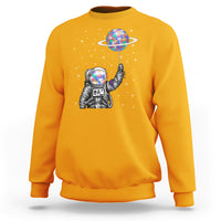 Gold astronaut graphic sweatshirt with colorful planet balloon and star pattern