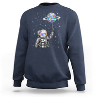Navy astronaut graphic sweatshirt with colorful planet balloon and star pattern