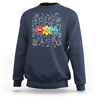 Navy sweatshirt with colorful science puzzle graphic on the chest.