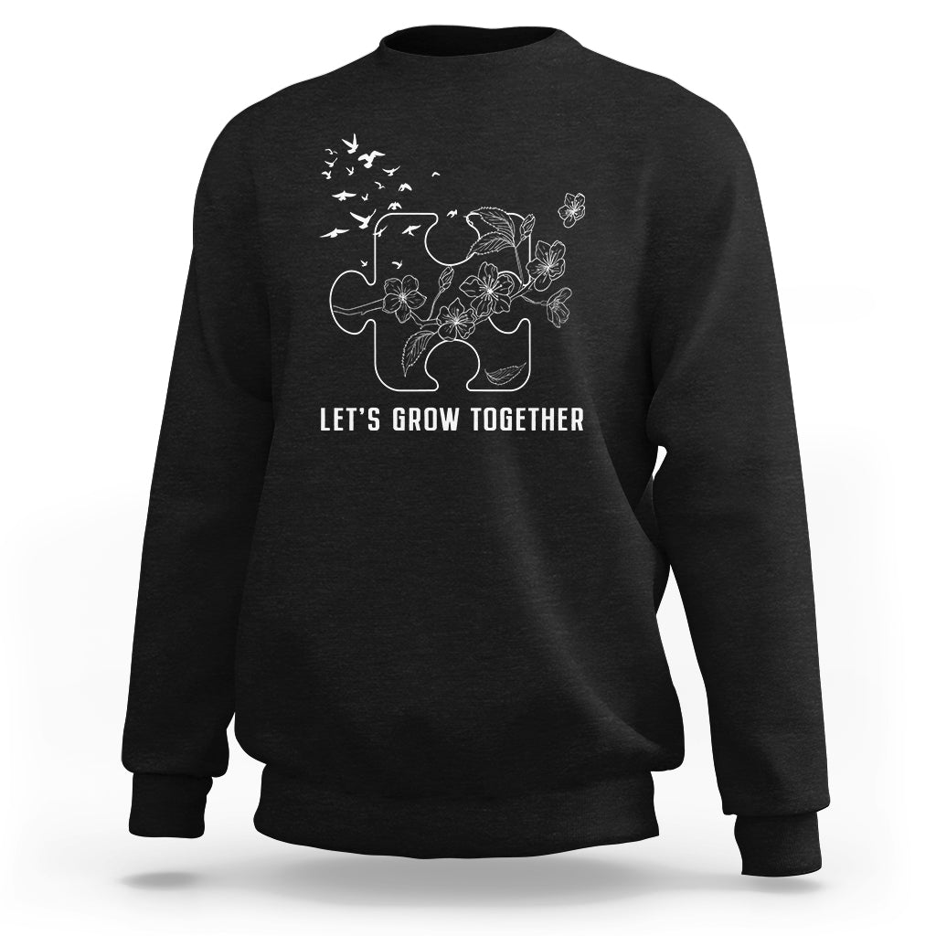 Black sweatshirt with white puzzle tree graphic and text "LET'S GROW TOGETHER"