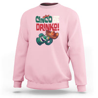 Light pink crewneck sweatshirt with “Cinco de Drinko” drink graphic on chest