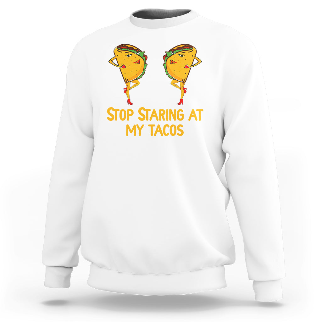 White sweatshirt with taco graphic and “Stop Staring At My Tacos” print