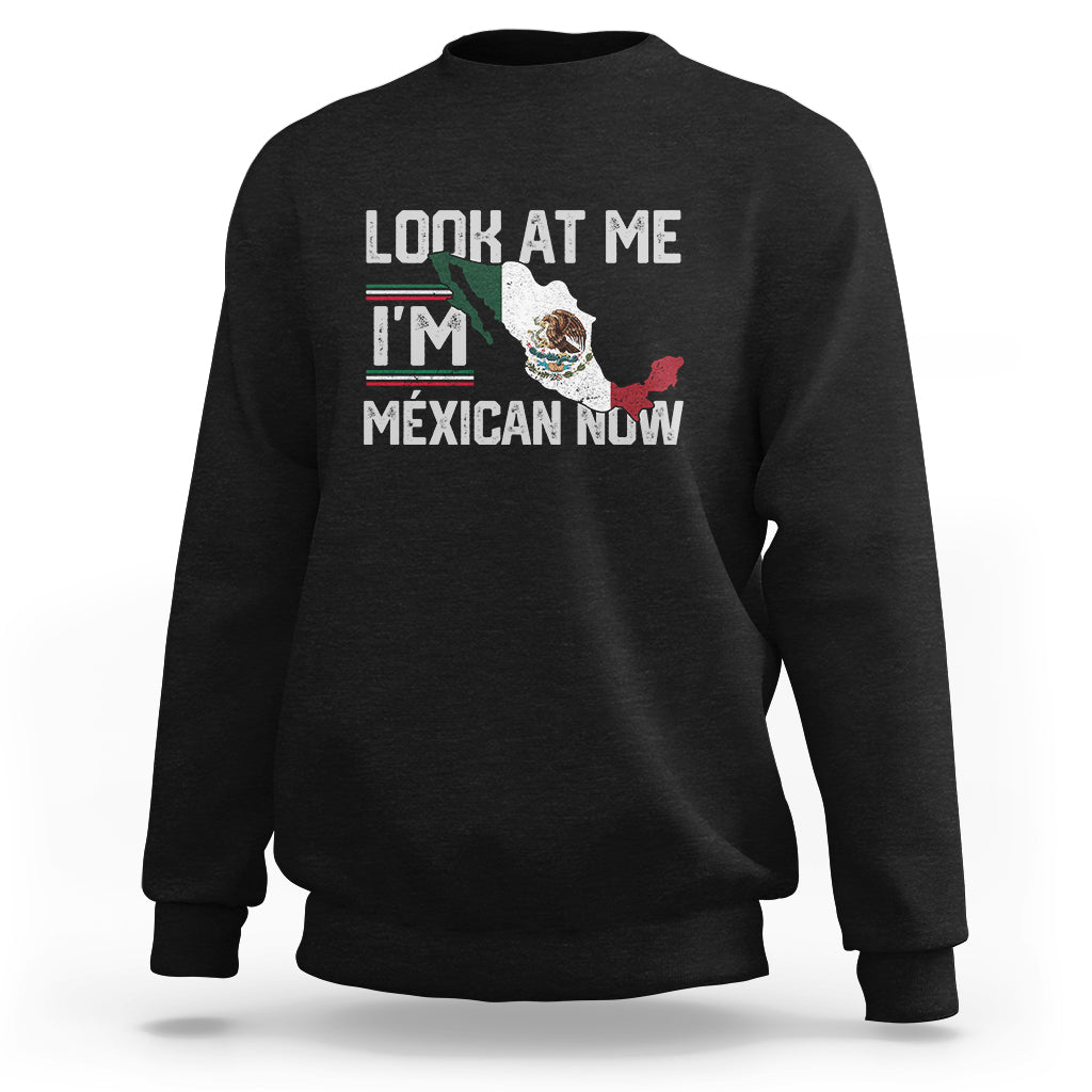 Black crewneck sweatshirt with front graphic reading "LOOK AT ME I'M MEXICAN NOW".