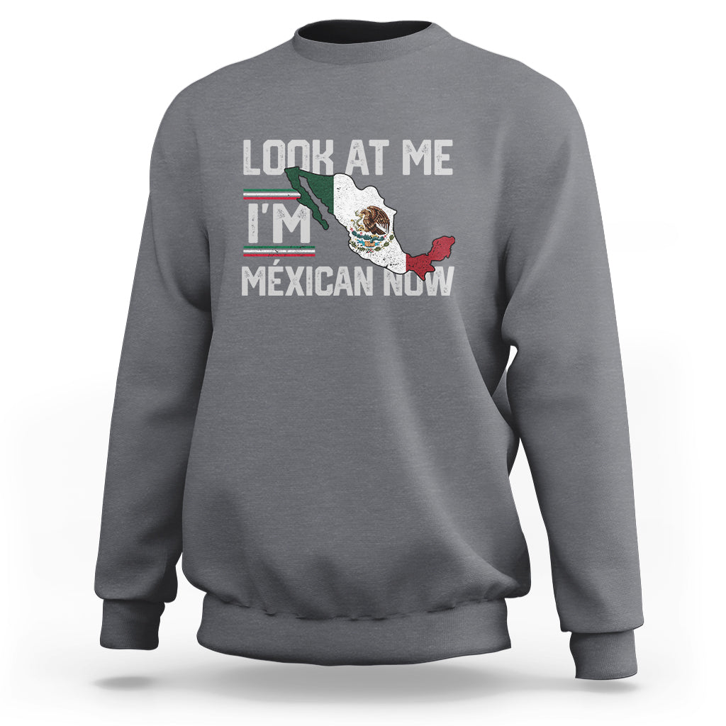 Gray crewneck sweatshirt with front graphic reading "LOOK AT ME I'M MEXICAN NOW".