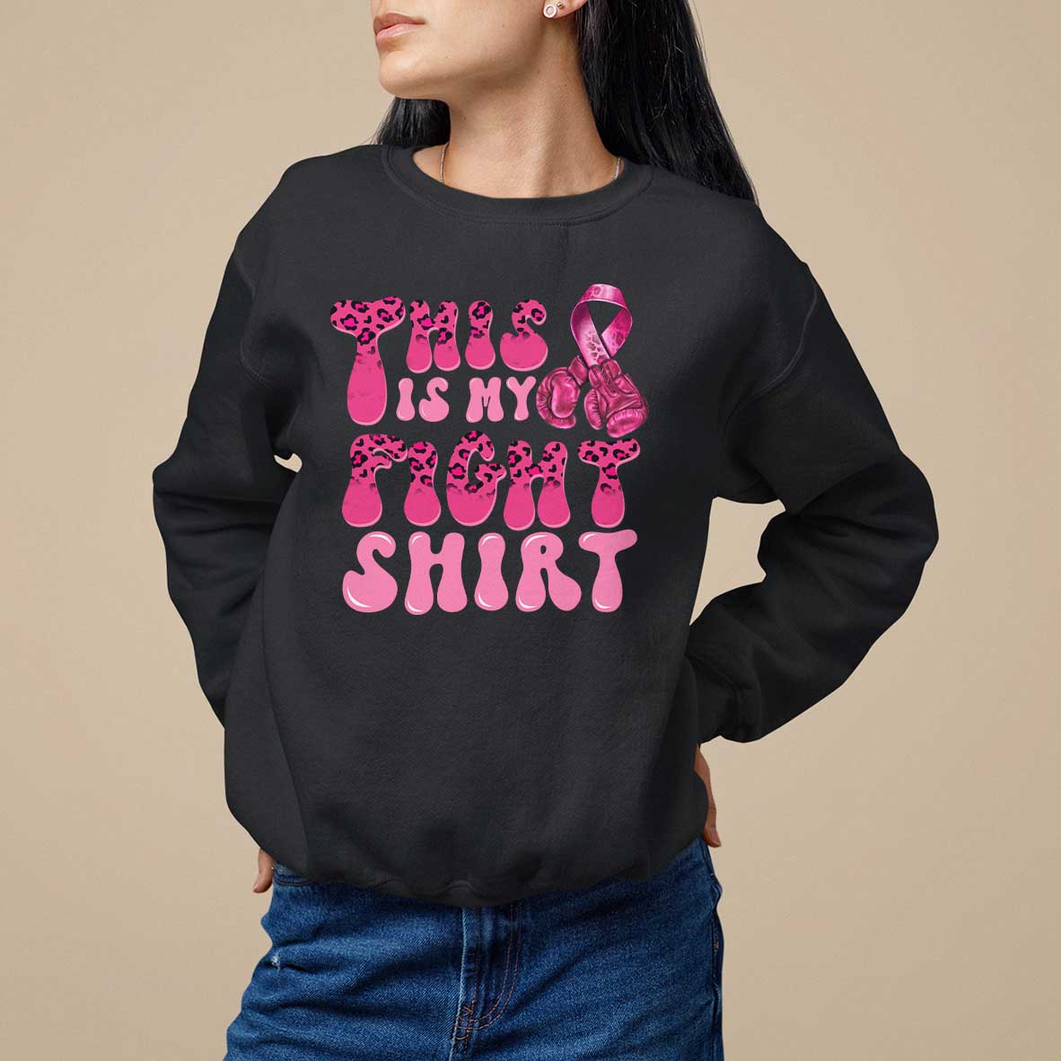 Black crewneck sweatshirt with pink ribbon awareness graphic and bold pink text