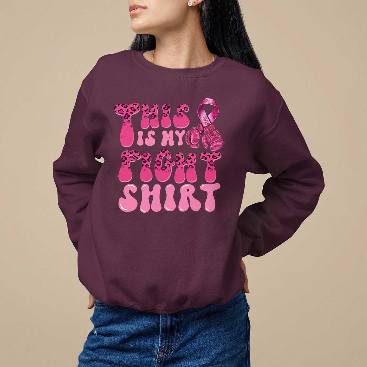 Maroon crewneck sweatshirt with pink ribbon awareness graphic and bold pink text