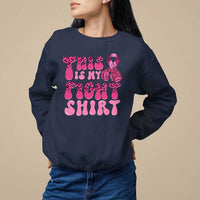 Navy crewneck sweatshirt with pink ribbon awareness graphic and bold pink text