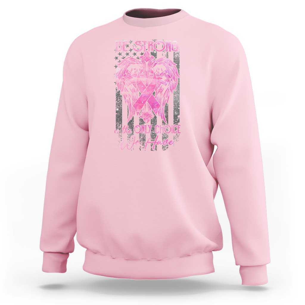 Light pink crewneck sweatshirt with pink ribbon graphic and 'Be Strong' slogan