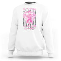 White crewneck sweatshirt with pink ribbon graphic and 'Be Strong' slogan