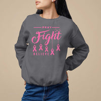 Dark gray crewneck sweatshirt with pink "Pray Fight Believe" text and ribbon graphic.