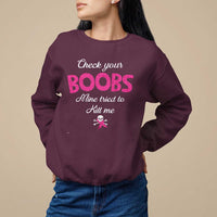 Maroon women’s awareness sweatshirt with pink ribbon and “Check your BOOBS” graphic.