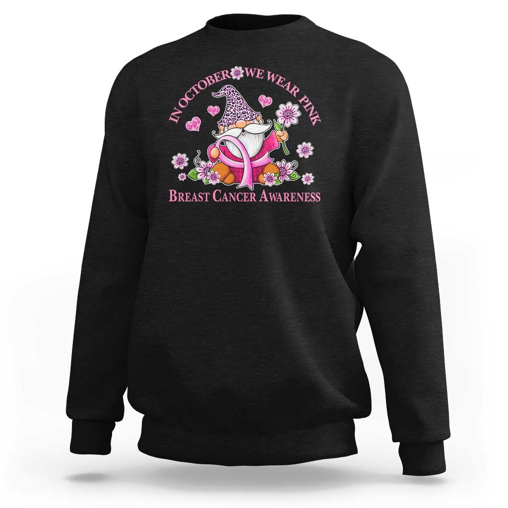 Black sweatshirt with back pink gnome graphic and “In October We Wear Pink” text