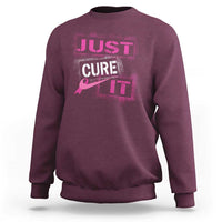 Maroon breast cancer awareness sweatshirt with “Just Cure It” chest graphic