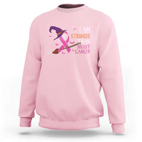 Light pink crewneck sweatshirt with pink ribbon witch graphic and “I AM STRONGER” text