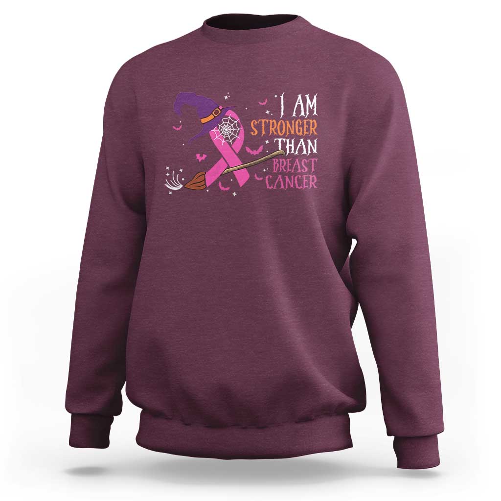 Maroon crewneck sweatshirt with pink ribbon witch graphic and “I AM STRONGER” text