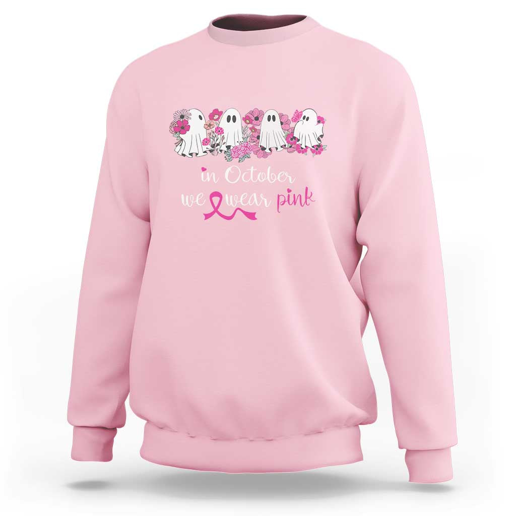 Light pink crewneck sweatshirt with ghost group graphic and “In October We Wear Pink” text