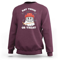 Halloween hockey sweatshirt, maroon; ghost hockey player graphic with “Hat Trick or Treat”