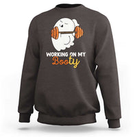 Dark chocolate crewneck sweatshirt with ghost lifting barbell graphic and “Working on My Booty” text