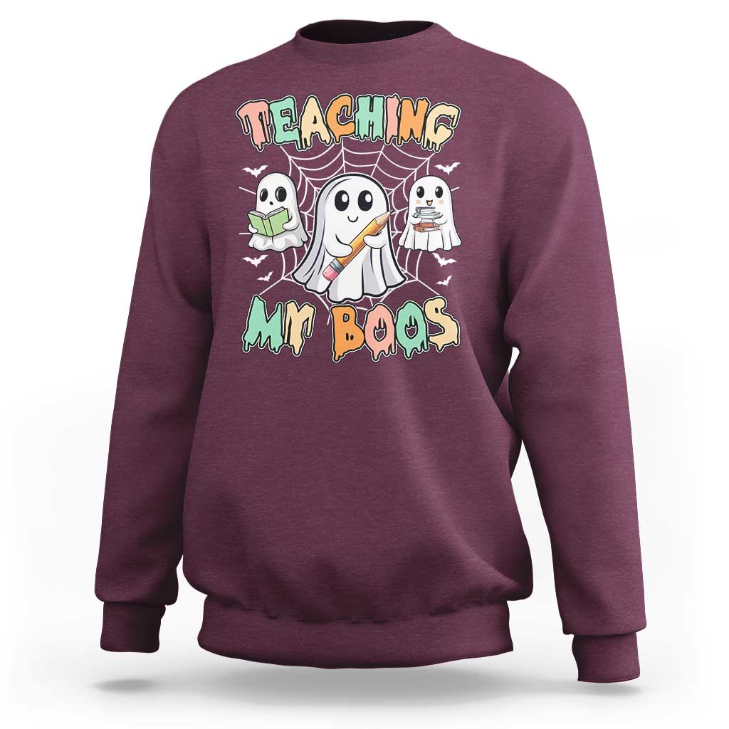 Maroon Halloween teacher sweatshirt with cute ghost graphic and Teaching My Boos text