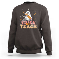 Dark chocolate Halloween teacher sweatshirt with cute ghost and “Trick or Teach” graphic