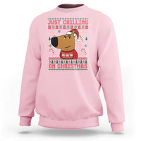 Light pink crewneck sweatshirt with “Just Chilling on Christmas” cartoon graphic