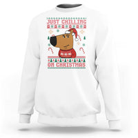 White crewneck sweatshirt with “Just Chilling on Christmas” cartoon graphic
