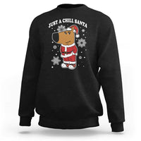 Black crewneck sweatshirt with "Just a Chill Santa" cartoon graphic on front