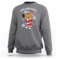Charcoal gray crewneck sweatshirt with "Just a Chill Santa" cartoon graphic on front