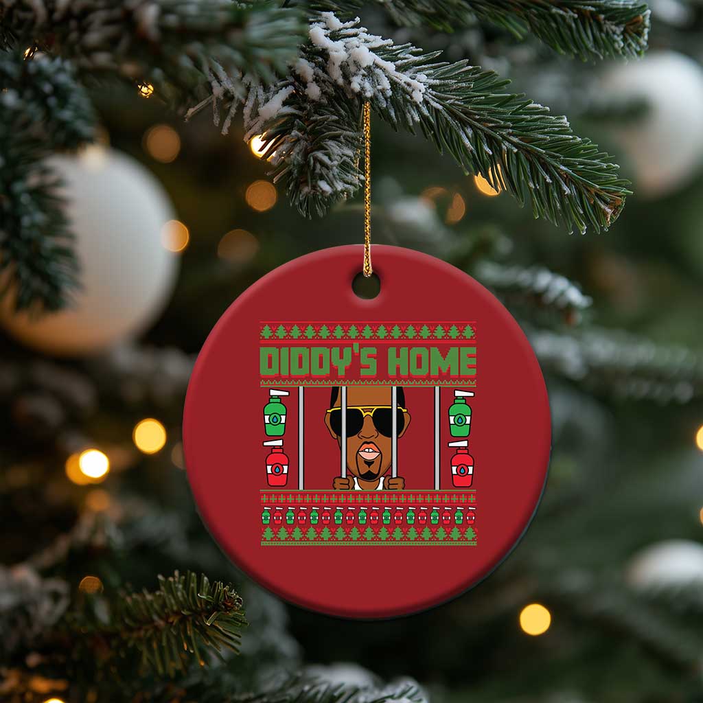 Red circular Christmas ornament with 'DIDDY'S HOME' graphic, hanging from gold string.