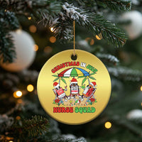 Gold round Christmas ornament with Nurse Squad Christmas in July graphic, hanging on tree.