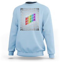 Light blue crewneck graphic sweatshirt with stacked PRIDEMONTH text and multicolor design