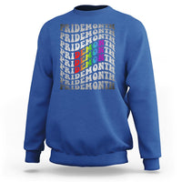 Royal blue crewneck graphic sweatshirt with stacked PRIDEMONTH text and multicolor design