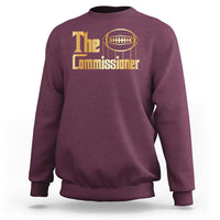 Maroon crewneck sweatshirt with 'The Commissioner' football graphic.