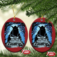 Two red oval Krampus ornaments with blue haunted house graphic and gold hanging loops