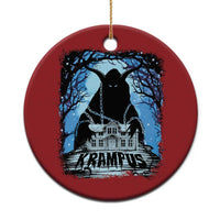 Red circular Krampus ornament with blue haunted house graphic and gold hanging loop