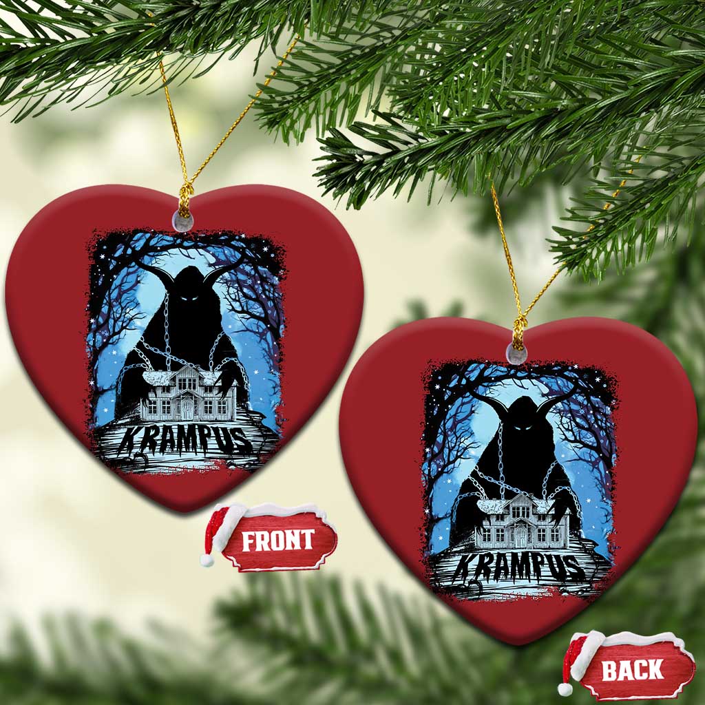 Two red heart-shaped Krampus ornaments with blue haunted house graphic and gold loops