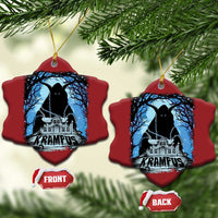 Two red scalloped Krampus ornaments with blue haunted house graphic and gold hanging loops