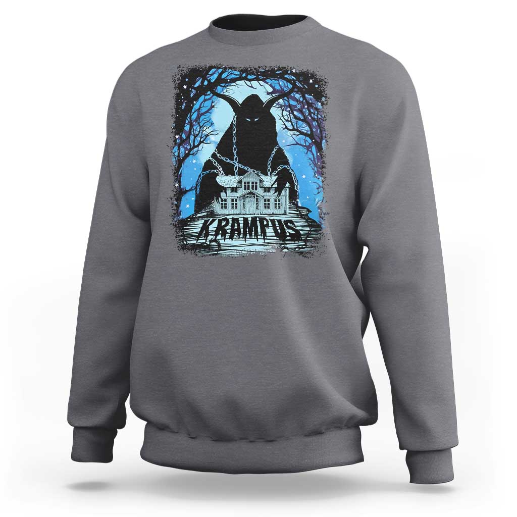 Charcoal crewneck sweatshirt with Krampus night house graphic and blue trees on chest.