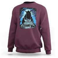 Maroon crewneck sweatshirt with Krampus night house graphic and blue trees on chest.
