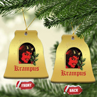 Gold bell-shaped hanging Christmas ornament with red-and-black horned female face and holly
