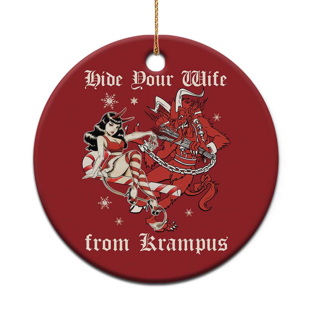 Red round Christmas ornament with Krampus-and-wife graphic, gold hanging loop.