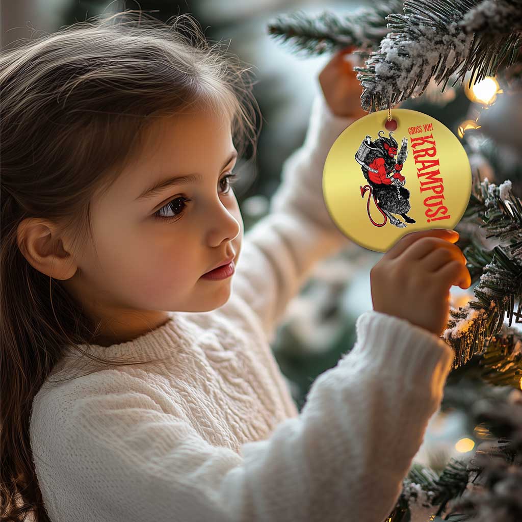 Gold round Krampus ornament on a Christmas tree, child reaching up to hold it