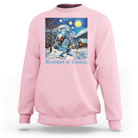 Light pink crewneck sweatshirt with front winter graphic of Krampus under a starry night