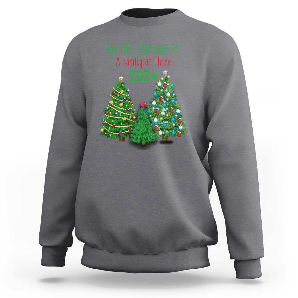 Charcoal gray Christmas sweatshirt with “Our First Christmas As A Family of Three 2024” graphic