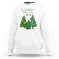 White Christmas sweatshirt with “Our First Christmas As A Family of Three 2024” graphic