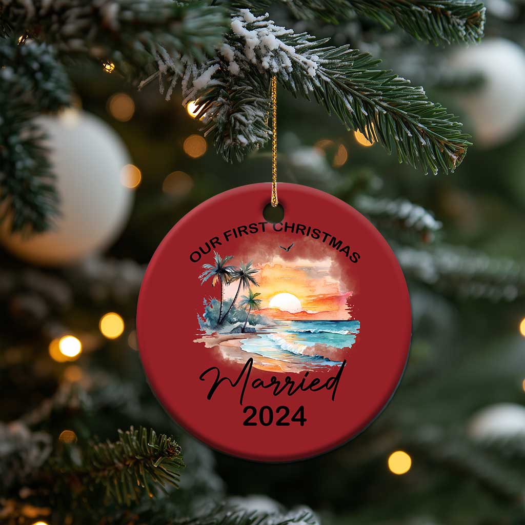 Red round Christmas ornament hanging on a tree, “Our First Christmas” and “Married 2024”