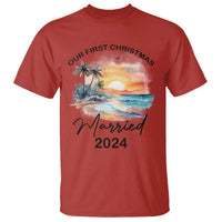 Red T-shirt with beach sunrise print, 'Our First Christmas' and 'Married 2024'.