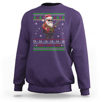 Purple Christmas sweatshirt with Santa holding toy gun and festive text graphic